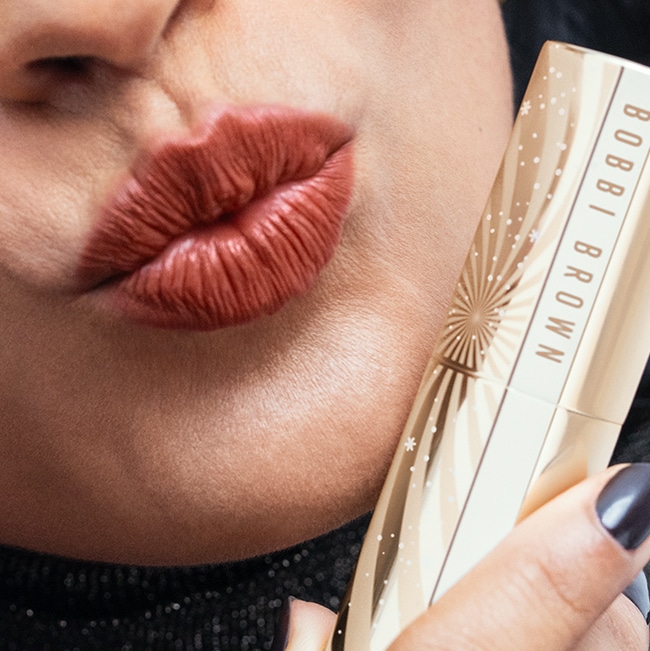 Close up of Long-Wear Cream Shadow Stick with swatch behind on top of a soft-grey background